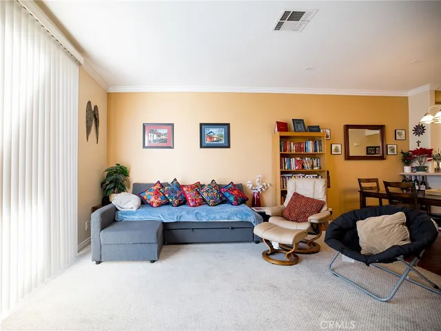 a living room with furniture and book shelf