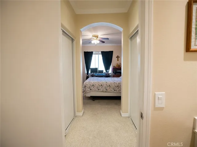 a view of a bedroom with bed and window