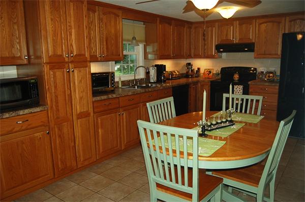 145 Star Avenue Woonsocket, RI 02895 - Photo 7 of 20 a kitchen with stainless steel appliances granite countertop a table chairs and a refrigerator