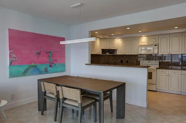 a kitchen with a sink a stove and cabinets