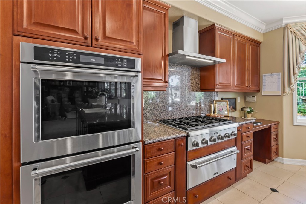 18 Asilomar Road Laguna Niguel, CA 92677 - Photo 26 of 75 a kitchen with stainless steel appliances granite countertop a stove and a microwave