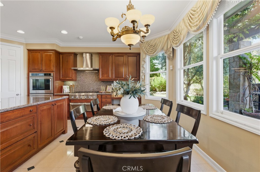 18 Asilomar Road Laguna Niguel, CA 92677 - Photo 28 of 75 a view of a dining room with furniture a chandelier and large windows
