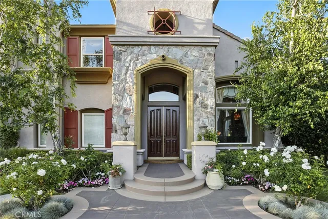 a view of a house with potted plants