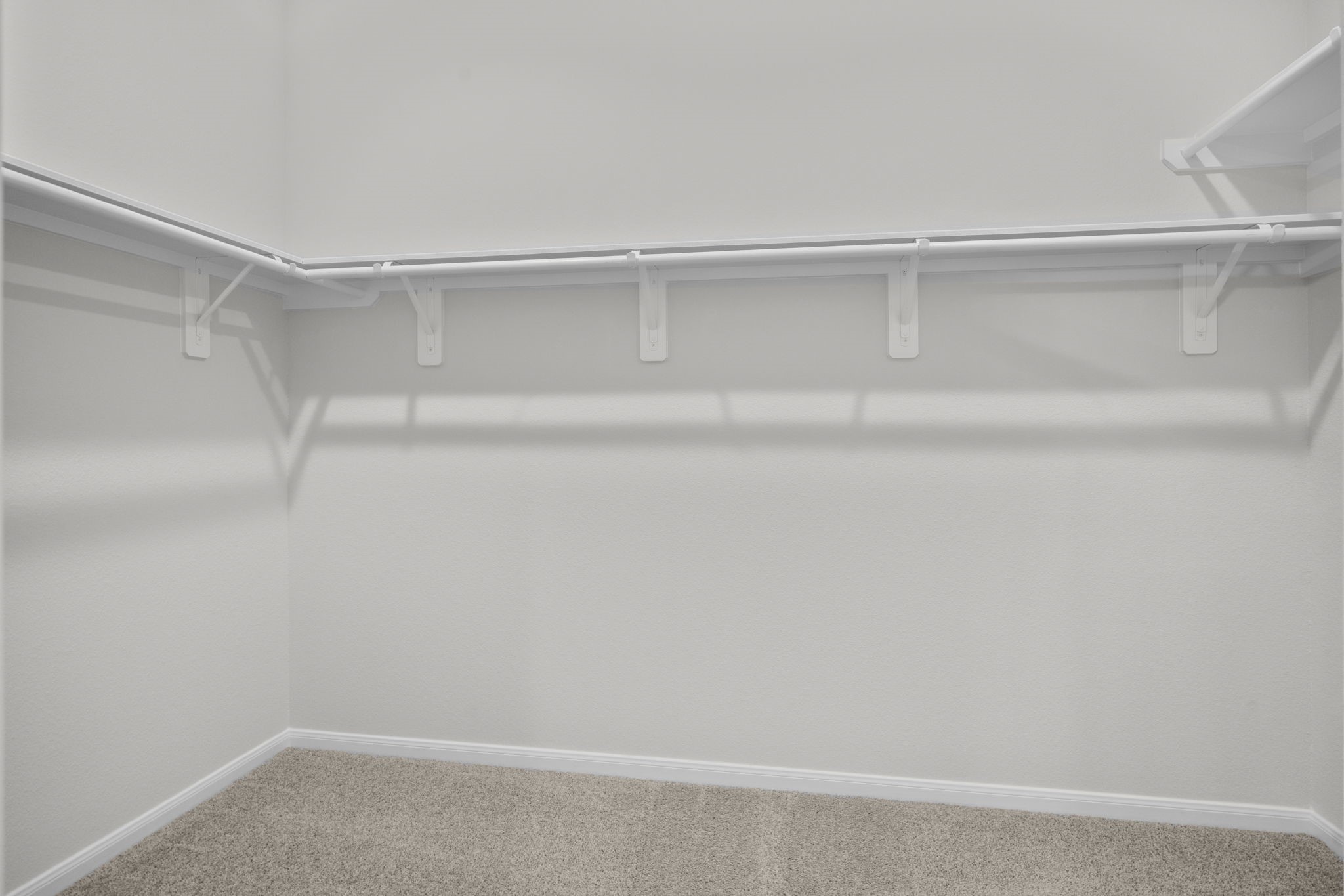 22223 Rome Breeze Drive Hockley, TX 77447 - Photo 16 of 46 The spacious walk-in closet provides ample storage with multiple hanging areas and shelving. Its thoughtful design keeps clothing and accessories organized while maintaining a clean, open feel.