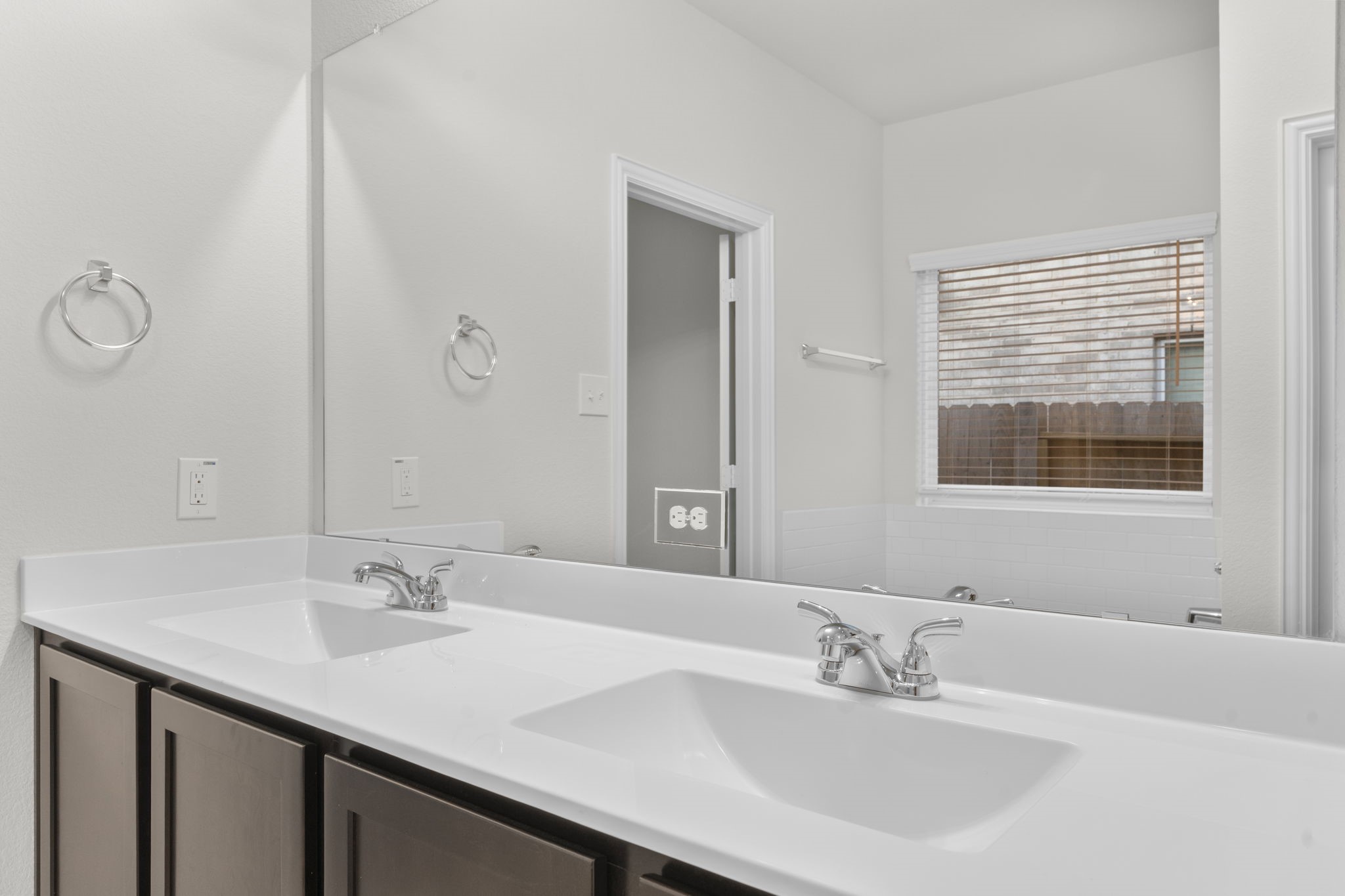 22223 Rome Breeze Drive Hockley, TX 77447 - Photo 19 of 46 Another view of the dual vanity showcases abundant counter space and contemporary fixtures. Natural light pours through the window, creating a bright and inviting start to every morning.