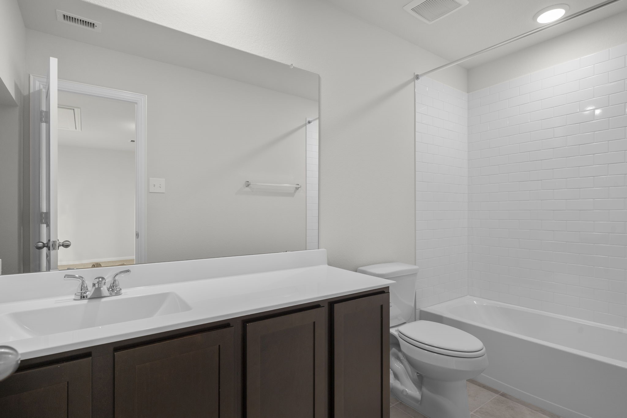 22223 Rome Breeze Drive Hockley, TX 77447 - Photo 24 of 46 The upstairs bathroom features a sleek modern design with a large mirror, extended vanity, and tub/shower combination. Its bright and clean look provides convenience for family and guests alike.