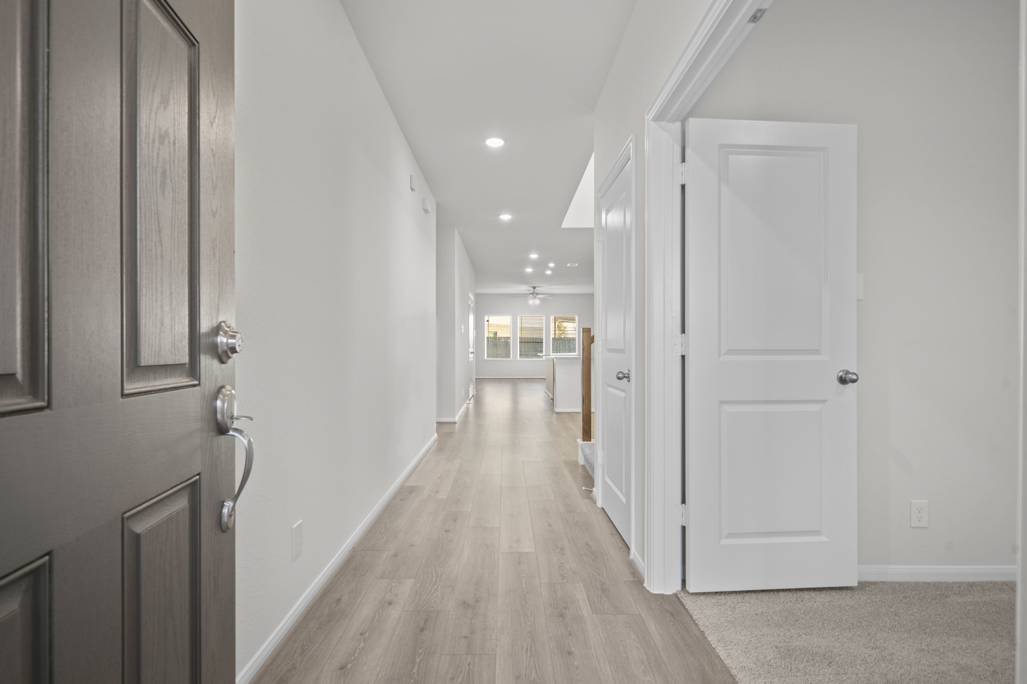 22223 Rome Breeze Drive Hockley, TX 77447 - Photo 2 of 46 Step inside through the beautiful front door to a bright, open hallway that showcases luxury tile wood flooring, recessed lighting, and a long view toward the spacious family room. Every detail is designed to give a warm and airy feel right from the entryway. Open the French doors to the private tucked away Home Office!