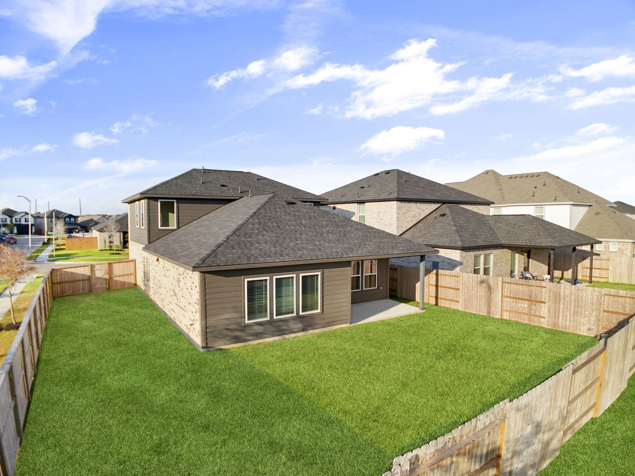 22223 Rome Breeze Drive Hockley, TX 77447 - Photo 29 of 46 Another aerial perspective displays the backyard’s full scale, fenced perimeter, and extended green area. The home’s layout and exterior design blend style and comfort while maximizing outdoor enjoyment.