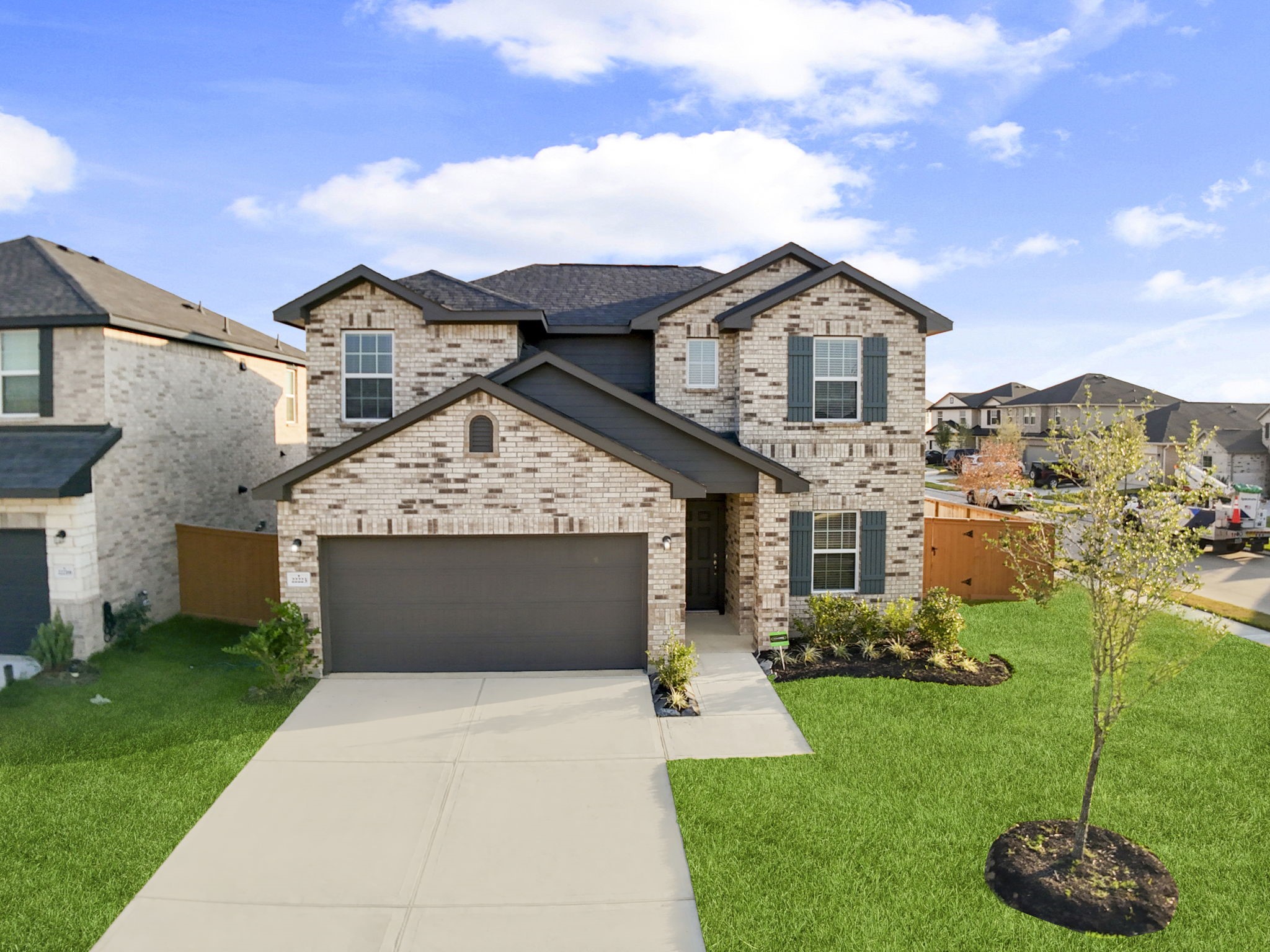 22223 Rome Breeze Drive Hockley, TX 77447 - Photo 32 of 46 The front view of the home showcases its classic brick elevation, manicured landscaping, and welcoming driveway. This picture-perfect curb appeal makes a wonderful first impression in a beautifully maintained neighborhood.