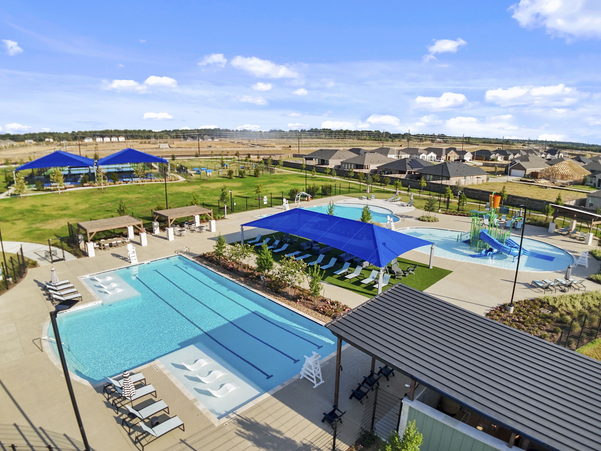 22223 Rome Breeze Drive Hockley, TX 77447 - Photo 42 of 46 A closer look at the pool area reveals ample shaded spaces and a splash zone designed for all ages. The vibrant surroundings and resort-like setting create a sense of everyday vacation living.