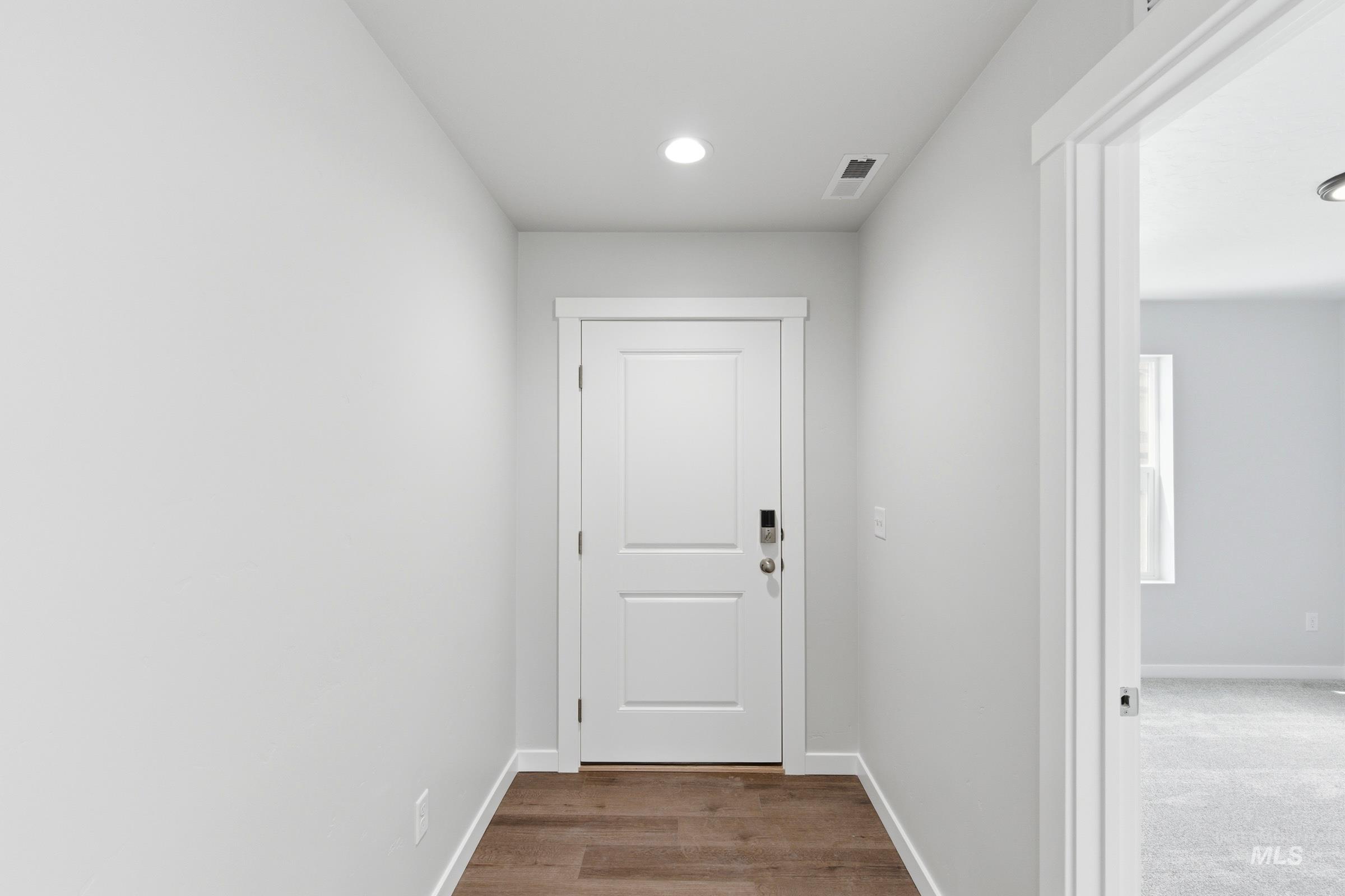 12829 Decatur Street Nampa, ID 83651 - Photo 2 of 33 Entryway featuring wood-finish flooring and a contemporary white door with paneling