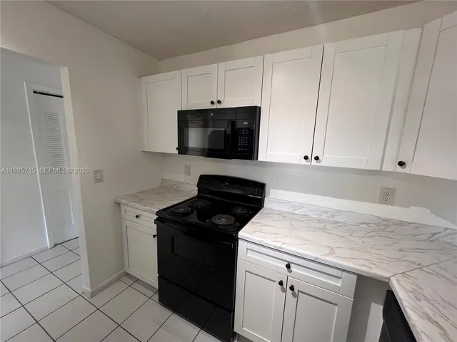 a kitchen with a sink appliances and cabinets