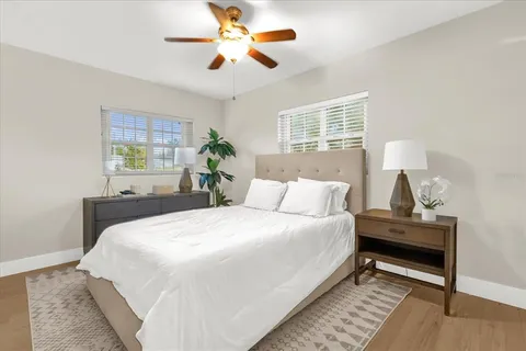 a bedroom with a bed and a chandelier