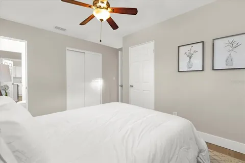 a bedroom with a bed and a chandelier