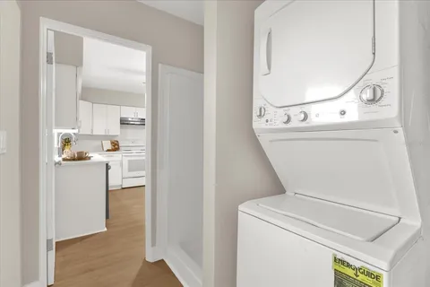 a kitchen with stainless steel appliances kitchen island a table and chairs in it