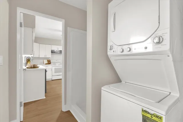 a kitchen with stainless steel appliances kitchen island a table and chairs in it