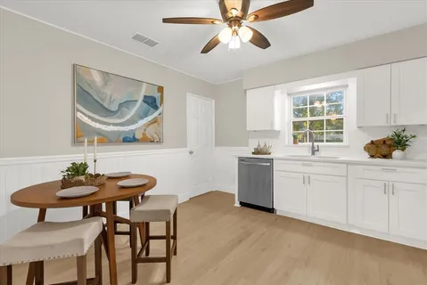 a kitchen with white cabinets and white appliances