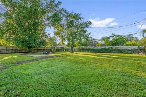 a swimming pool with outdoor seating and yard