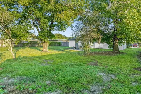 a front view of house with yard and trees