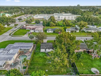 an aerial view of residential houses with outdoor space and street view