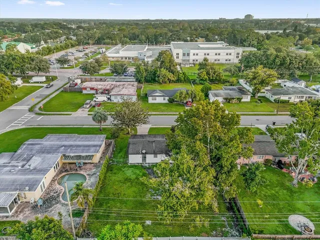an aerial view of residential houses with outdoor space and street view