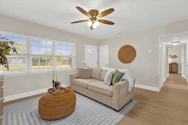 a living room with furniture and a large window