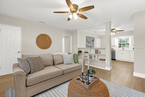 a living room with furniture a rug and a window