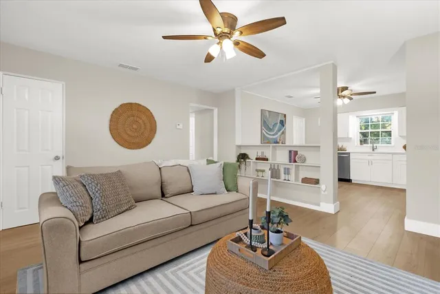 a living room with furniture a rug and a window