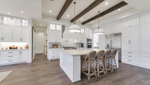 a kitchen with stainless steel appliances granite countertop a stove and a refrigerator