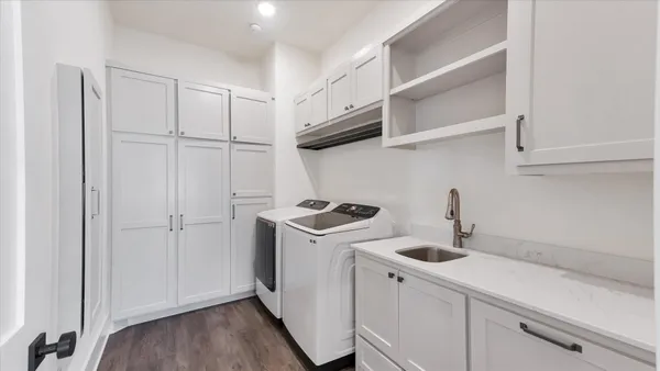 a kitchen with granite countertop a sink a counter top space appliances and cabinets