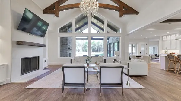 a living room with furniture and a chandelier