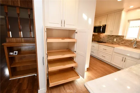 a large kitchen with kitchen island granite countertop a large window a sink and stainless steel appliances