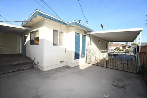 a front view of a house with a yard fire pit and outdoor seating