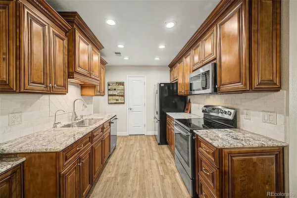 a kitchen with a sink stove top oven and cabinets