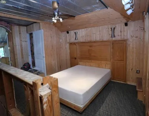 a bedroom with a bed and a chandelier