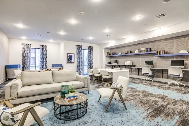 a kitchen with stainless steel appliances a stove a sink a oven a dining table and chairs