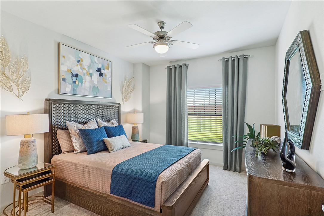 6000 Jones Road, Unit 4301 Bryan, TX 77807 - Photo 12 of 16 a bedroom with a large bed and a chandelier