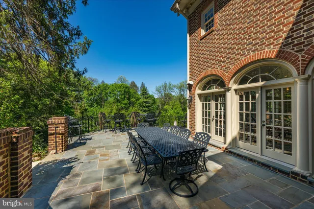 a view of a patio with table and chairs and potted plants