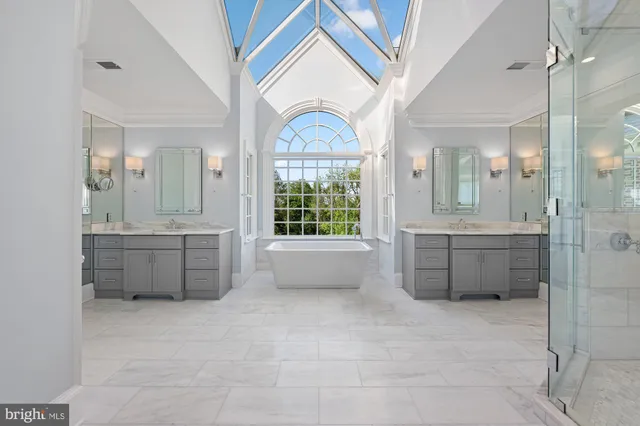 a bathroom with a tub sink and mirror