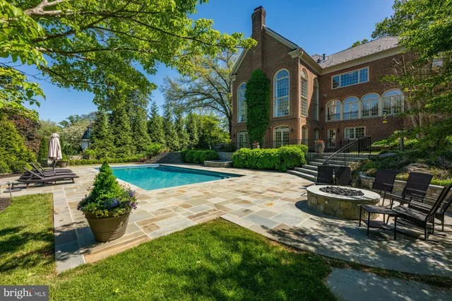 a front view of a house with a yard and a fountain