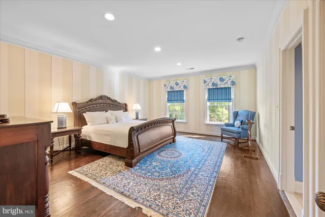 a bedroom with a bed wooden floor and a window
