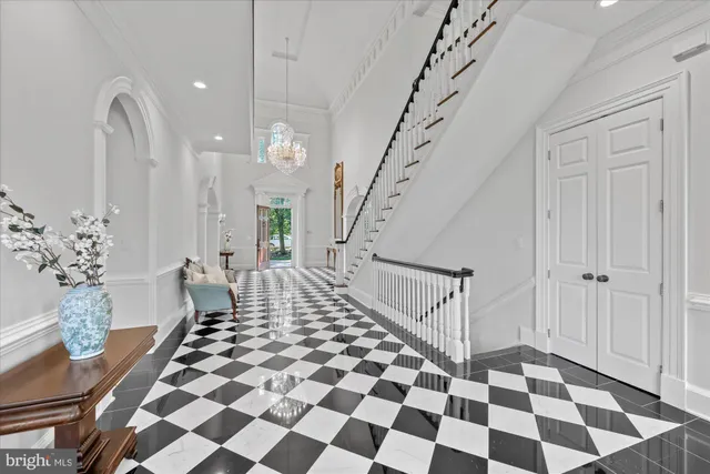 a view of a hallway with front door and wooden floor
