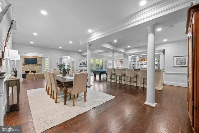 an entryway and dining room with wooden floor