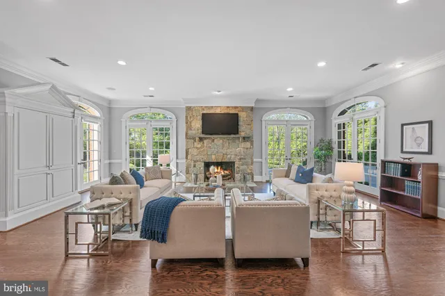 a living room with fireplace furniture and a large window