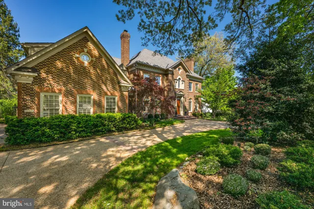 a view of a large brick building next to a yard