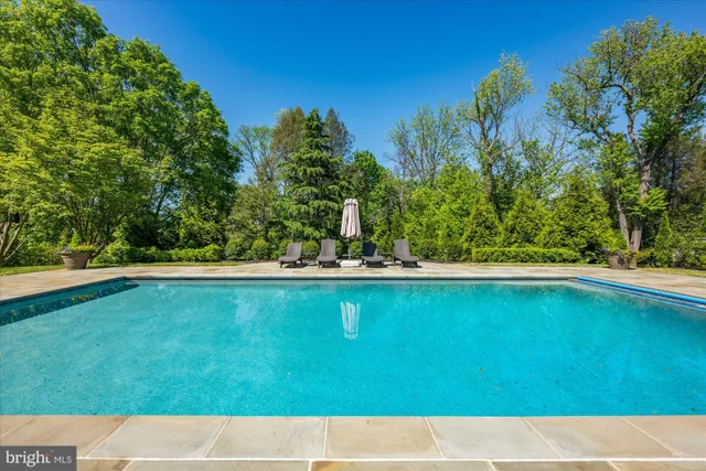 a view of swimming pool with an outdoor space and seating area