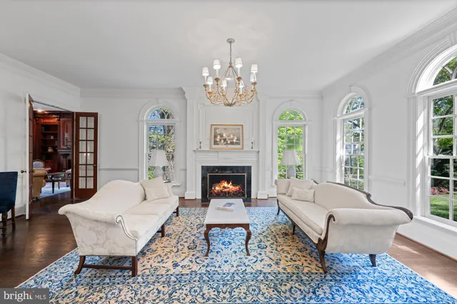 a living room with furniture a fireplace and a table