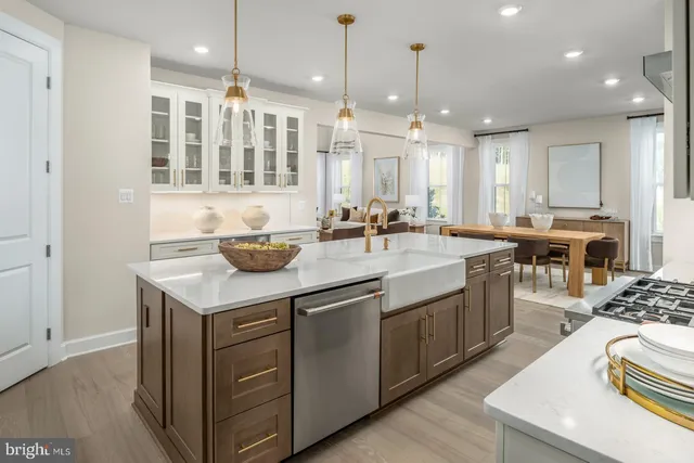 a kitchen with kitchen island granite countertop a sink and a stove