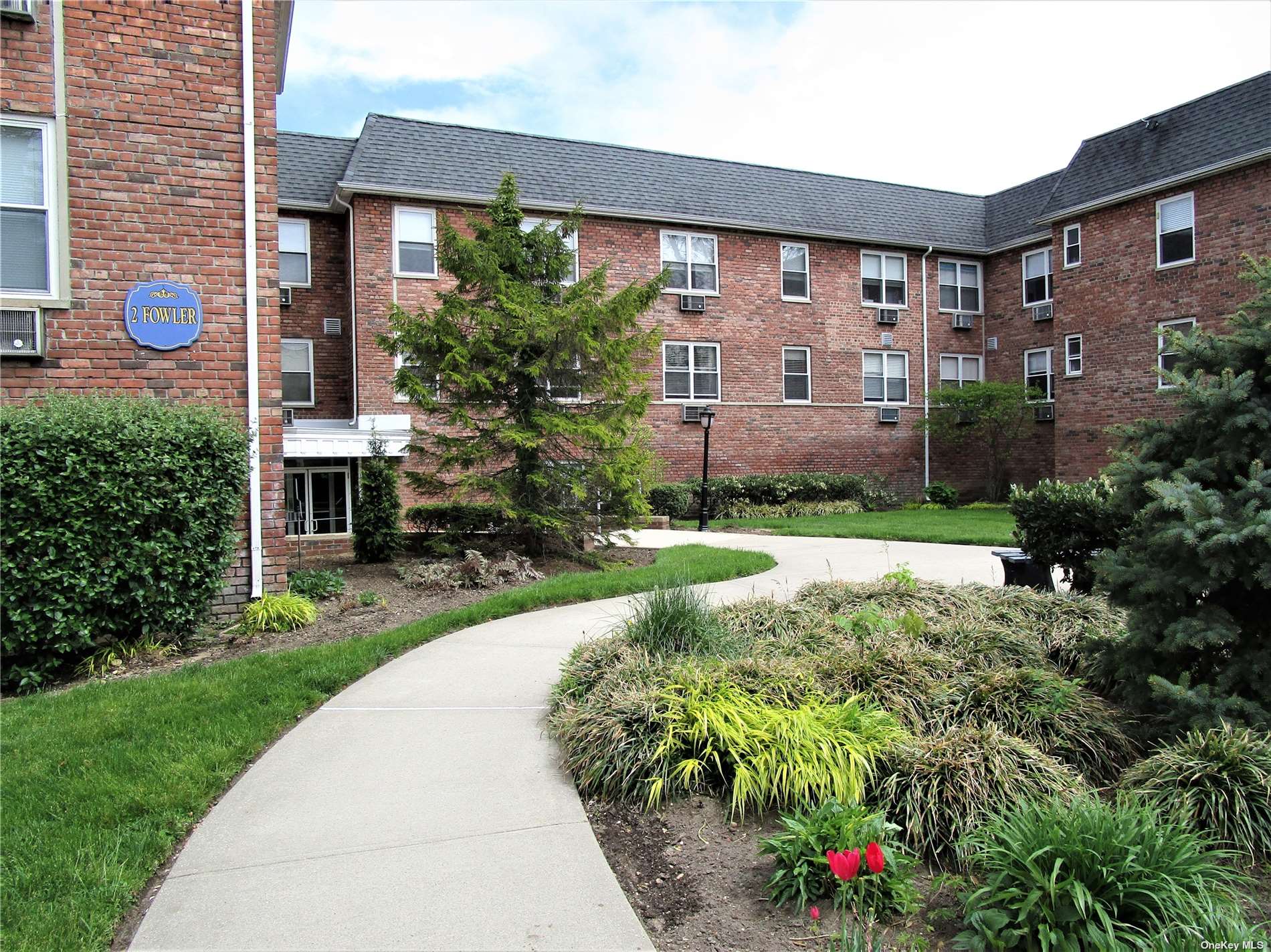 a front view of a house with a yard and porch