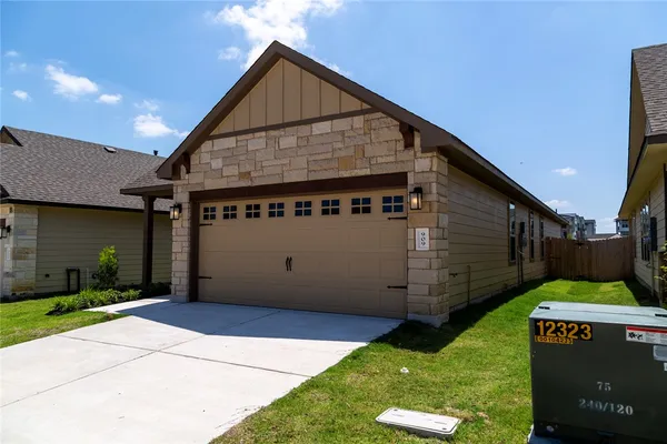 a view of a house with a wooden fence
